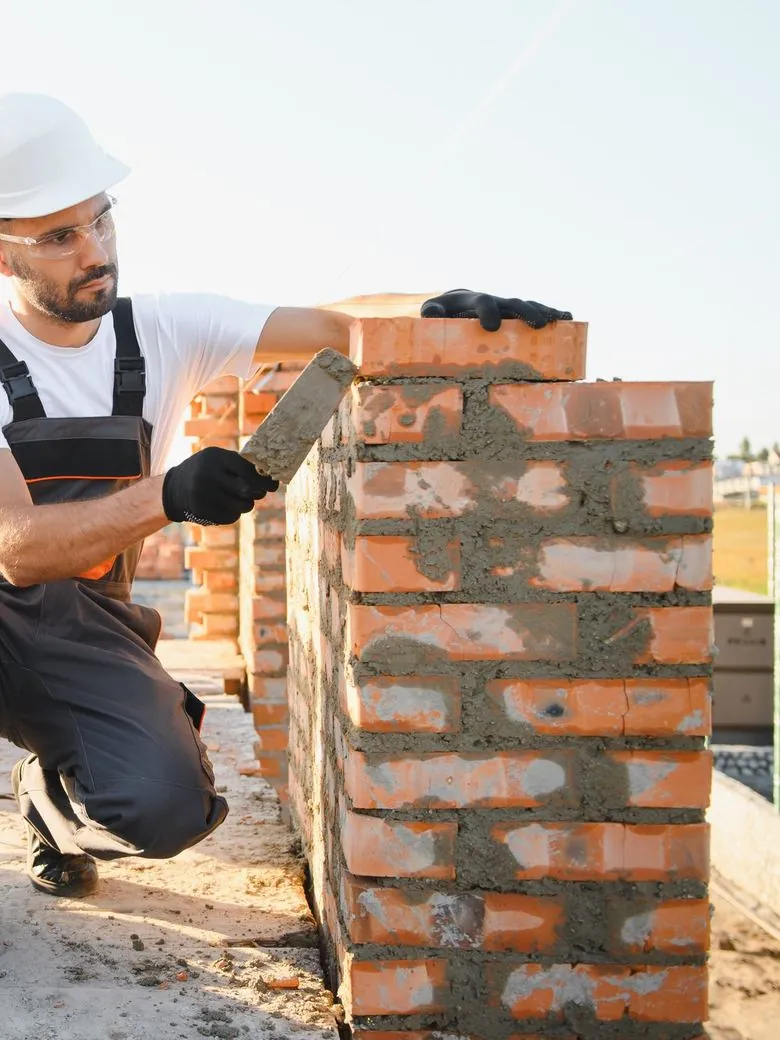 Bricklayer building a garden wall