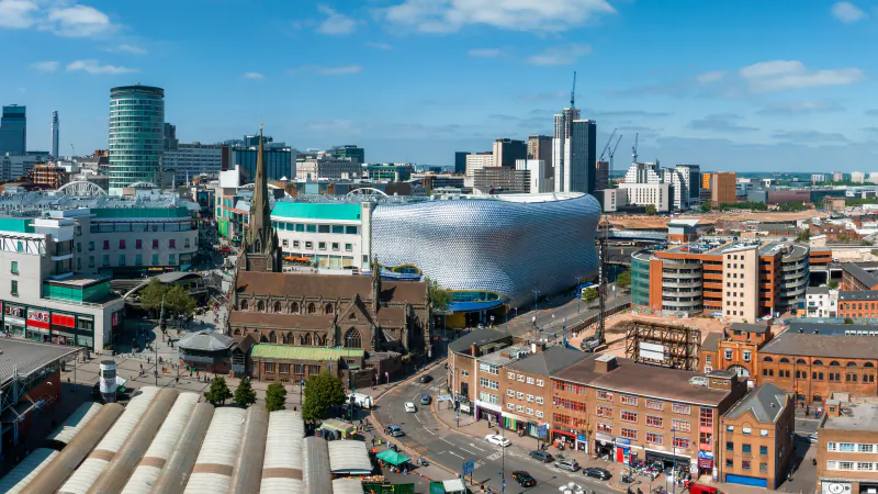 The Birmingham skyline with St Martin in the Bull Ring church, the Selfridges building and the outdoor market