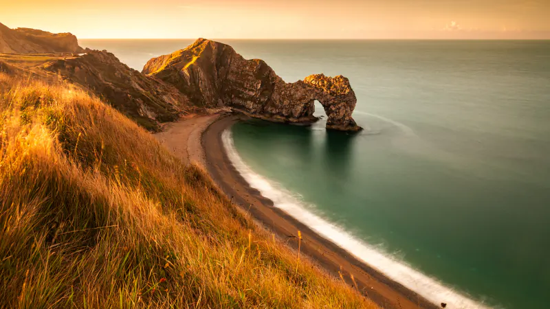 Durdle Door, the natural limestone arch on the Jurassic Coast in Dorset, at sunrise