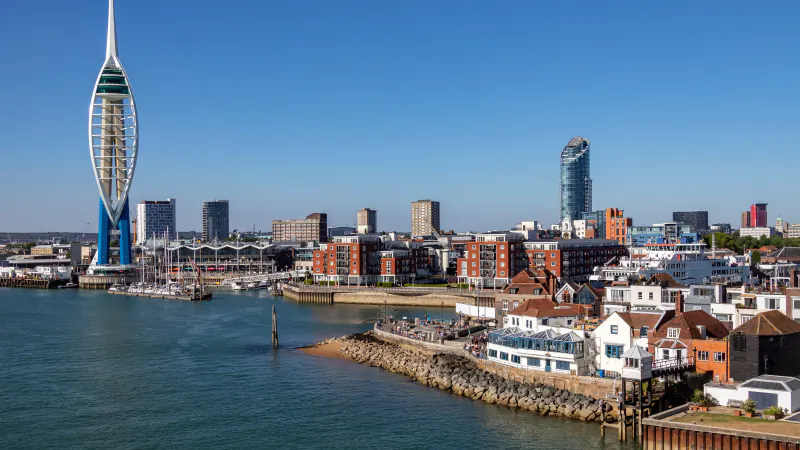 The Spinnaker Tower rising above the harbour and the waterfront houses of Old Portsmouth