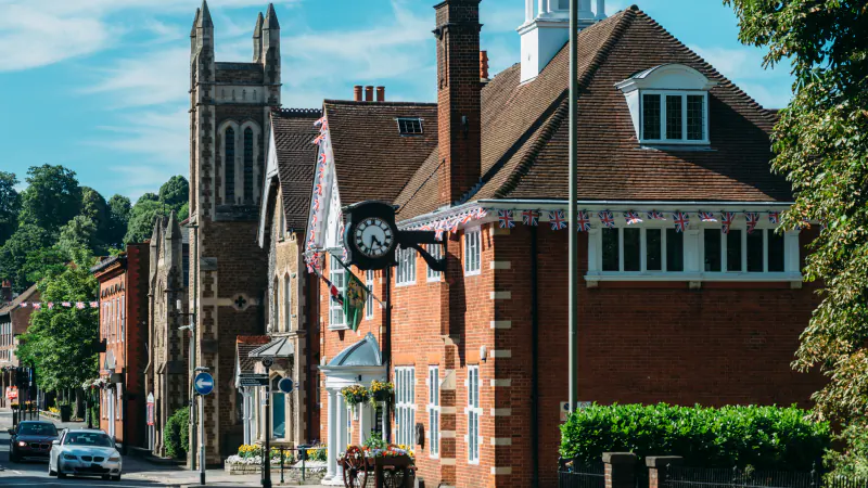 Traditional red-brick buildings and a street clock in the historic centre of Farnham, Surrey