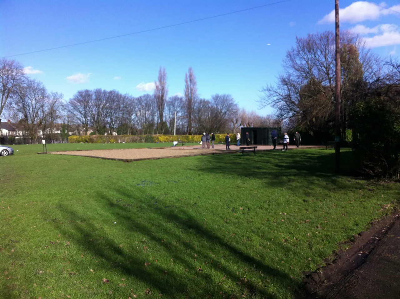 Path through Ashburton Park in Addiscombe on a sunny day with people walking