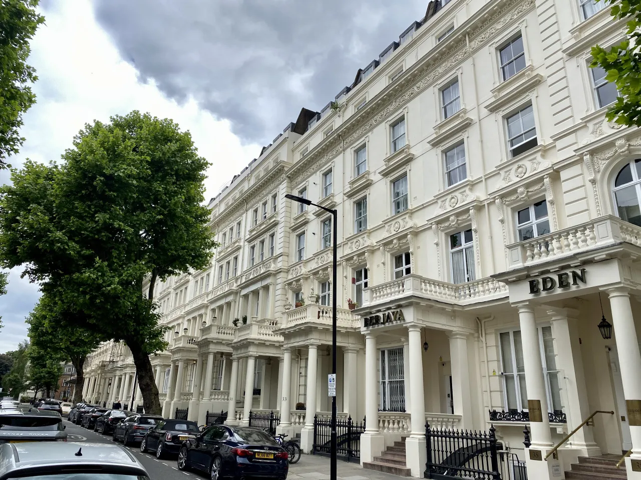 Stucco terraces on Inverness Terrace, Bayswater, with parked cars