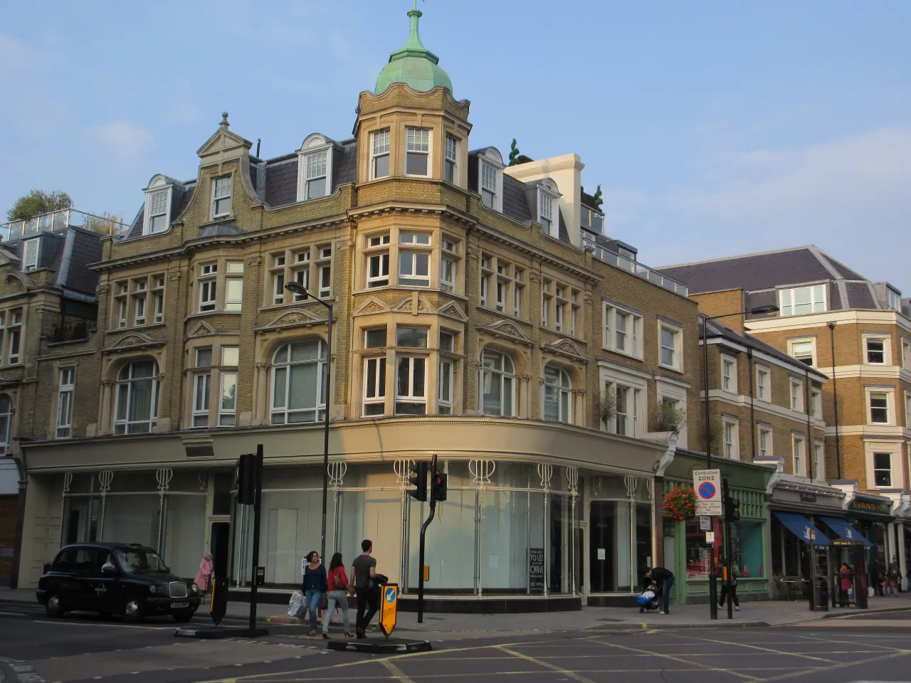 Shops on the corner of Westbourne Grove and Chepstow Road, Bayswater, with pedestrians