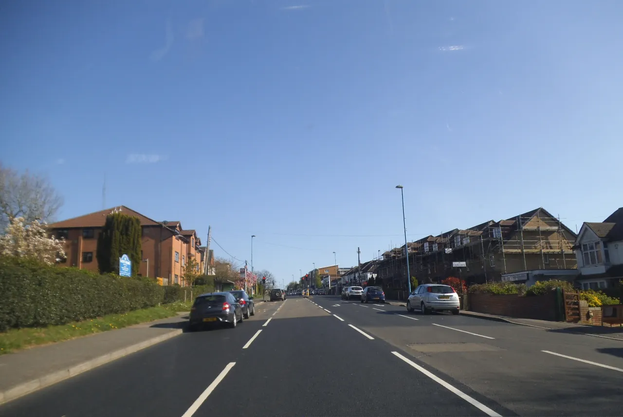 Main Road, Biggin Hill, lined with shops and homes on a clear day
