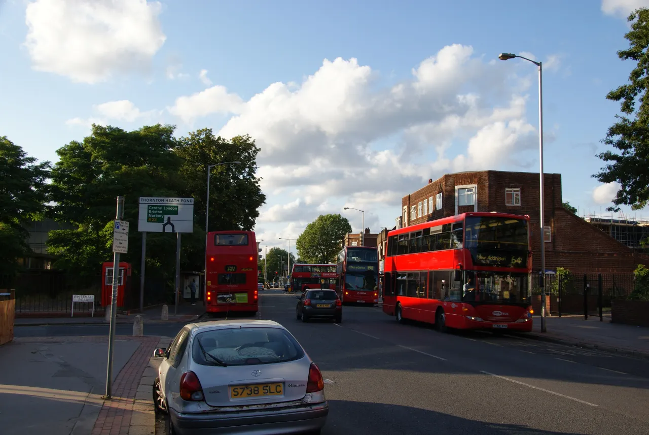 Thornton Heath Pond road junction with buses, a short distance from Broad Green