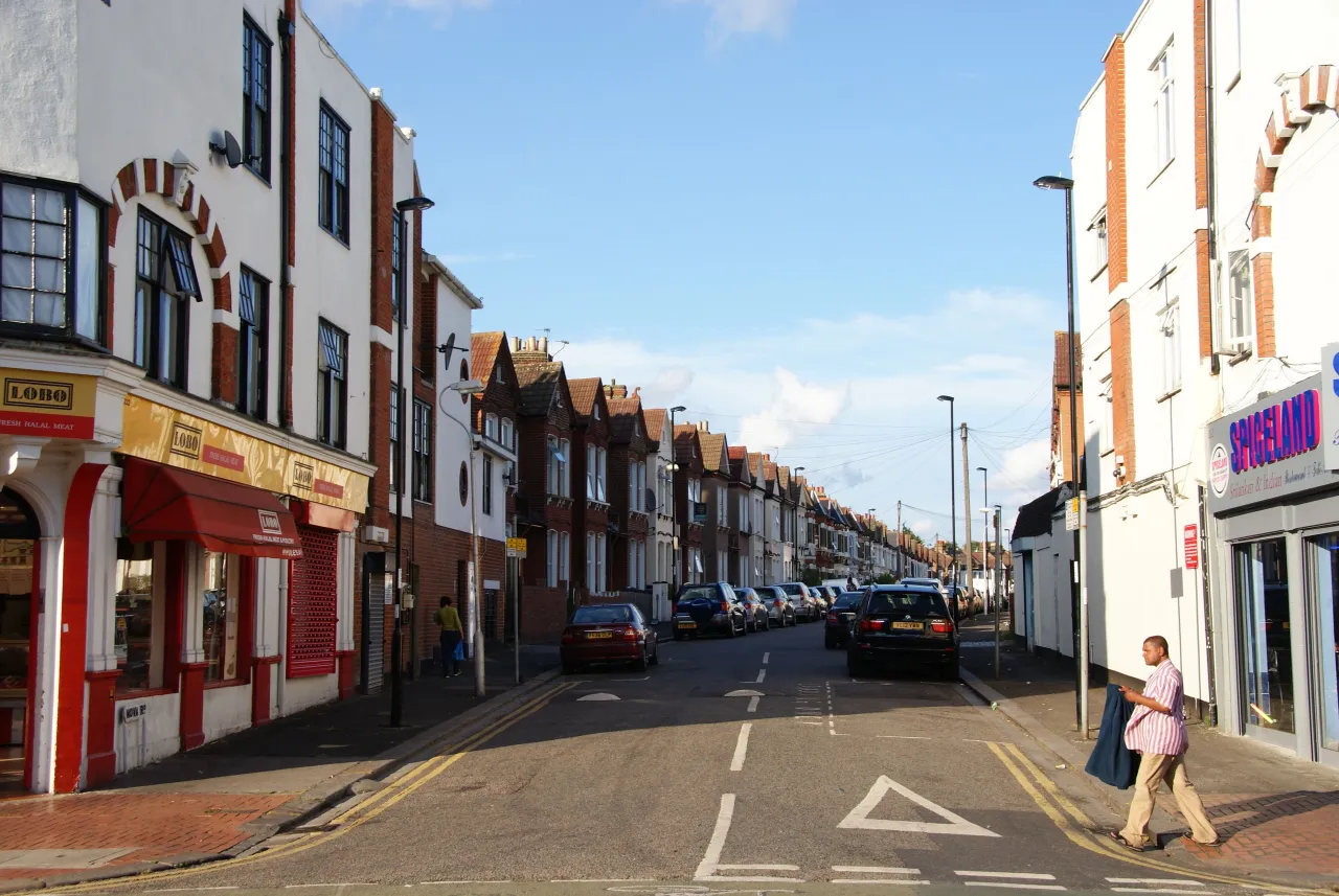 London Road in Broad Green, Croydon, with shops and pedestrians on a sunny day