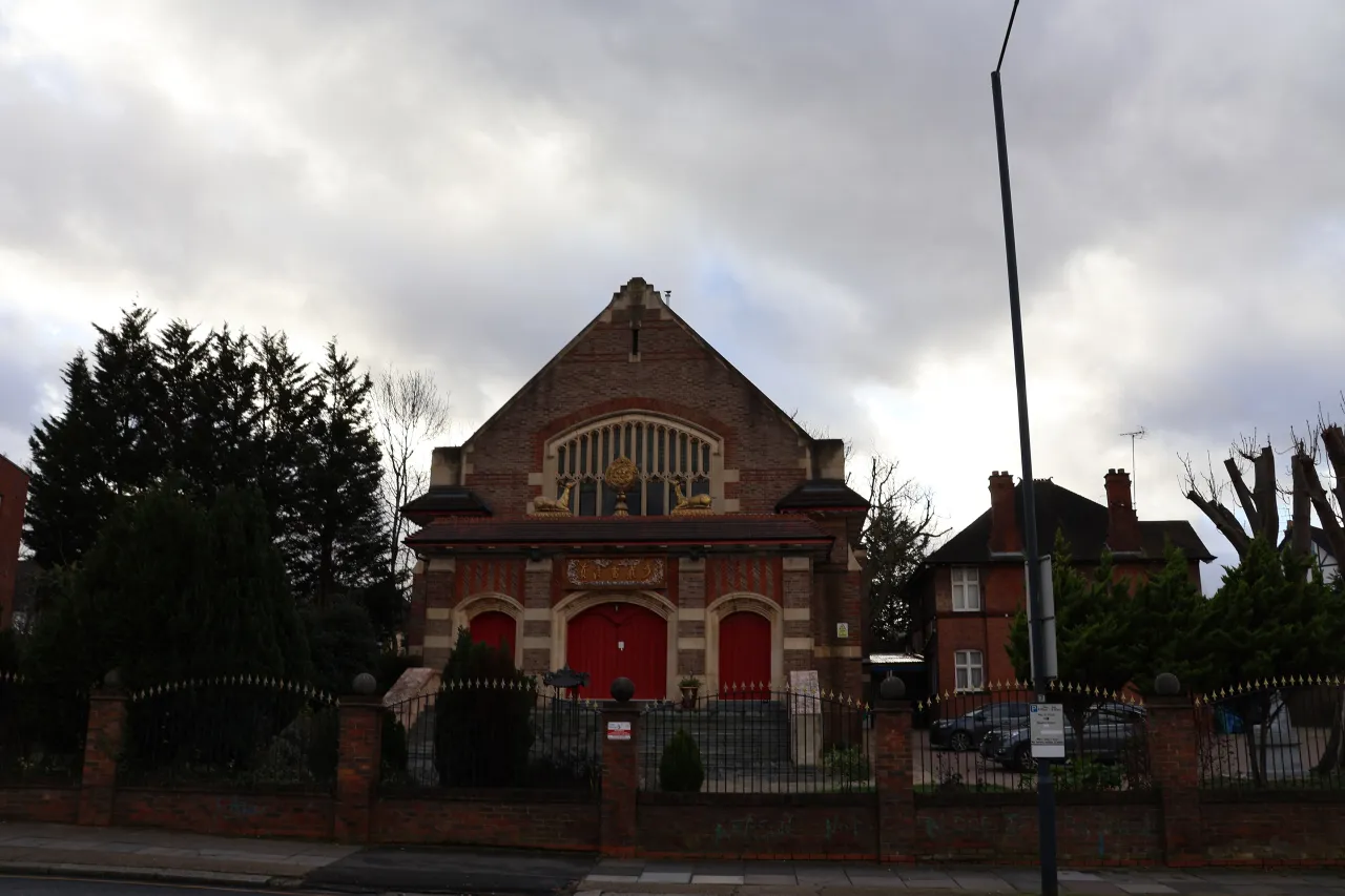 A red-brick church building on Willesden Lane, on the edge of Brondesbury Park