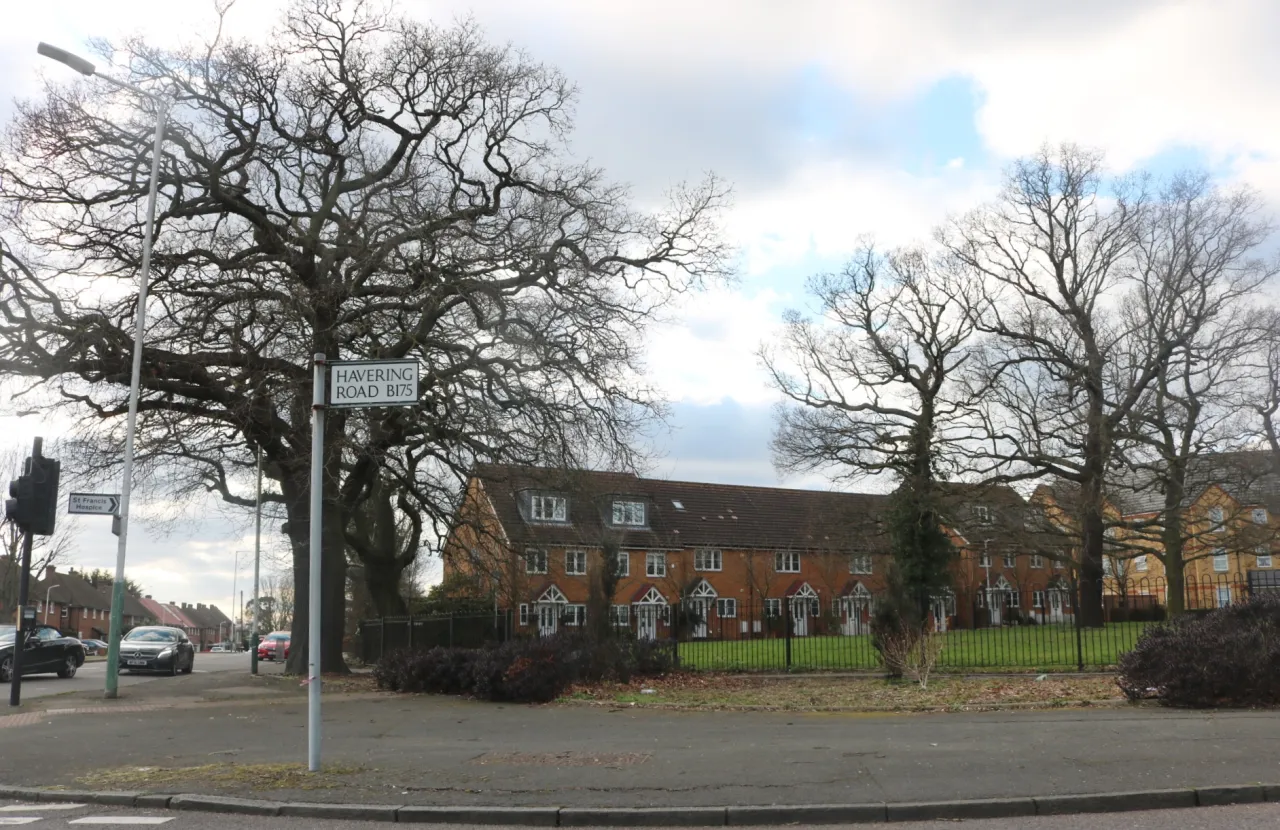 Havering Road at the corner of Chase Cross Road, with houses and green space