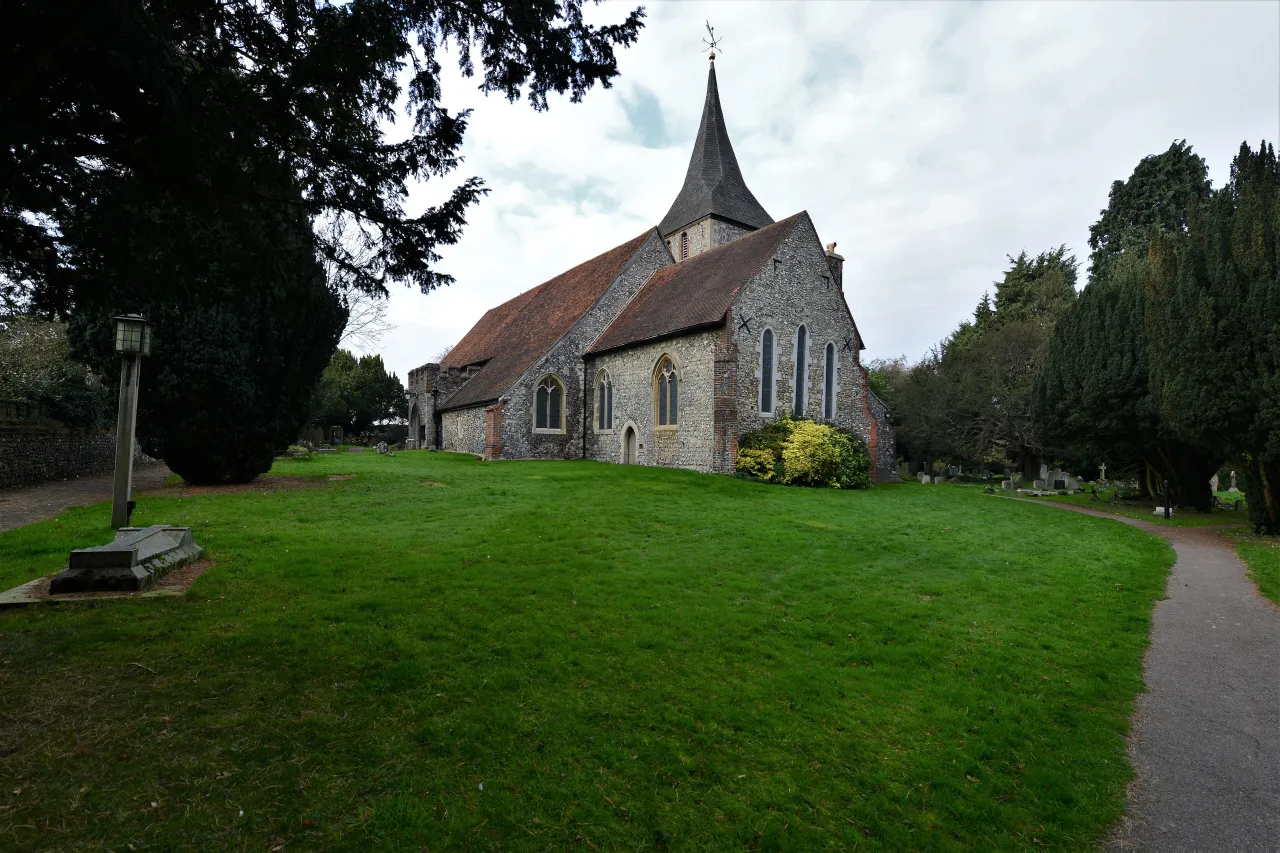 St Martin of Tours parish church in Chelsfield village, seen across its churchyard lawn village church