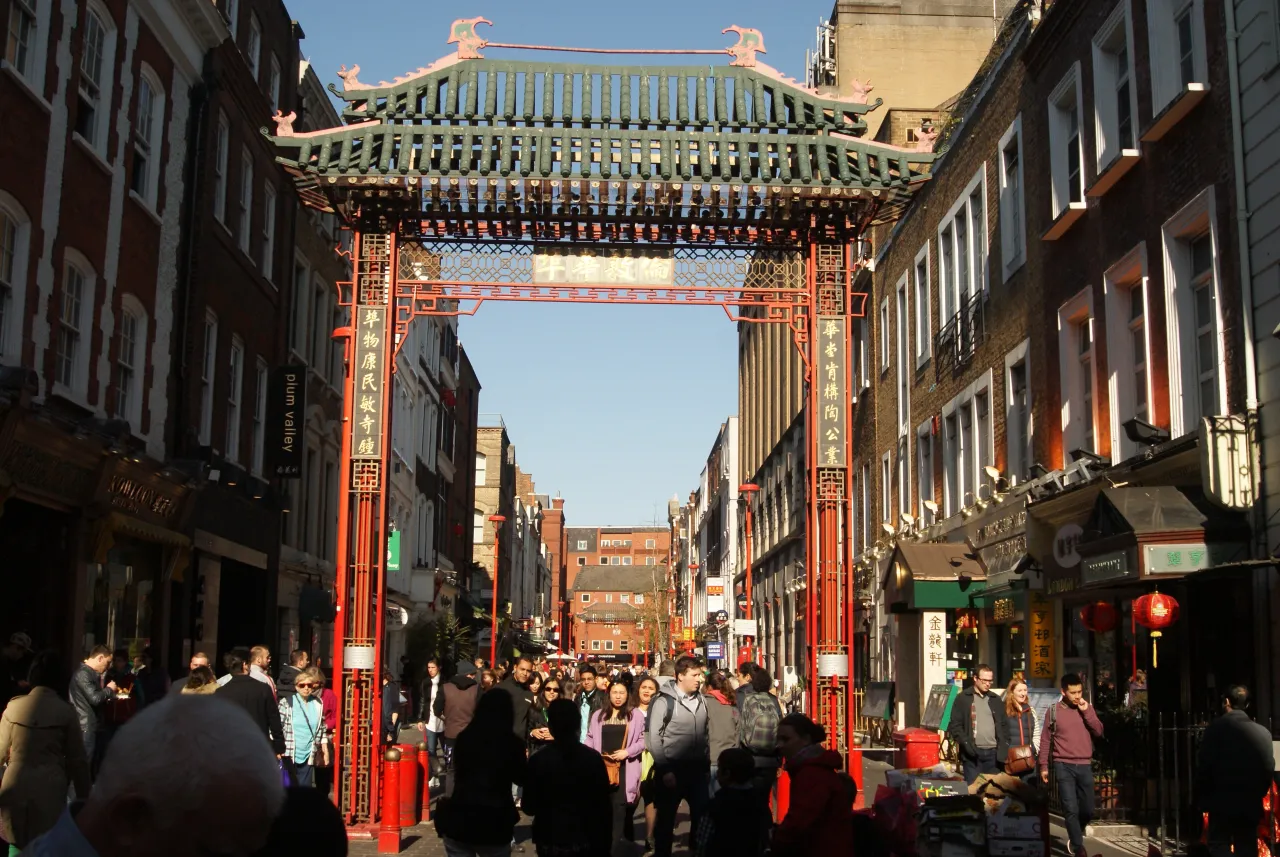 The ceremonial gate into Chinatown on Gerrard Street, London, busy with visitors