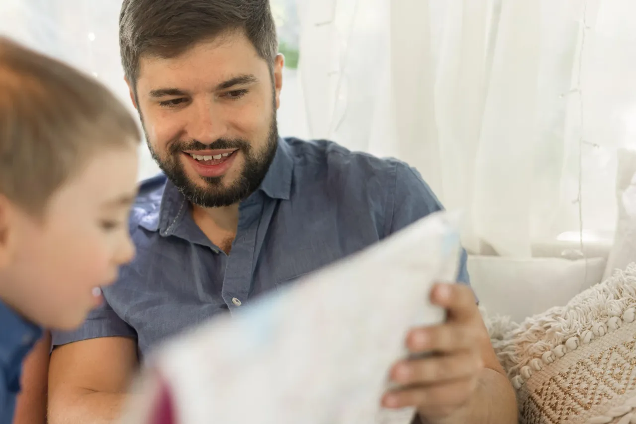 A father and son looking over trip details together before booking a group journey