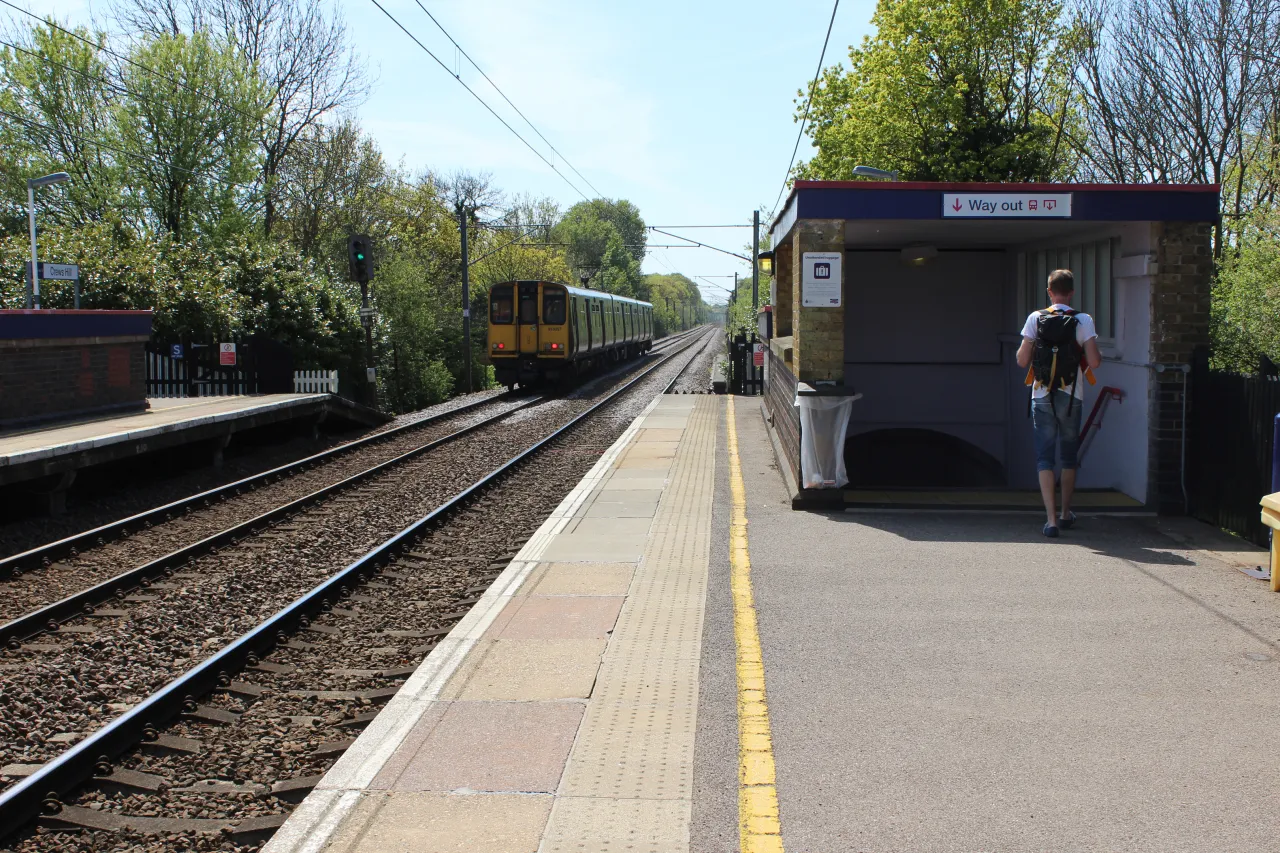 Crews Hill railway station platform with a train arriving