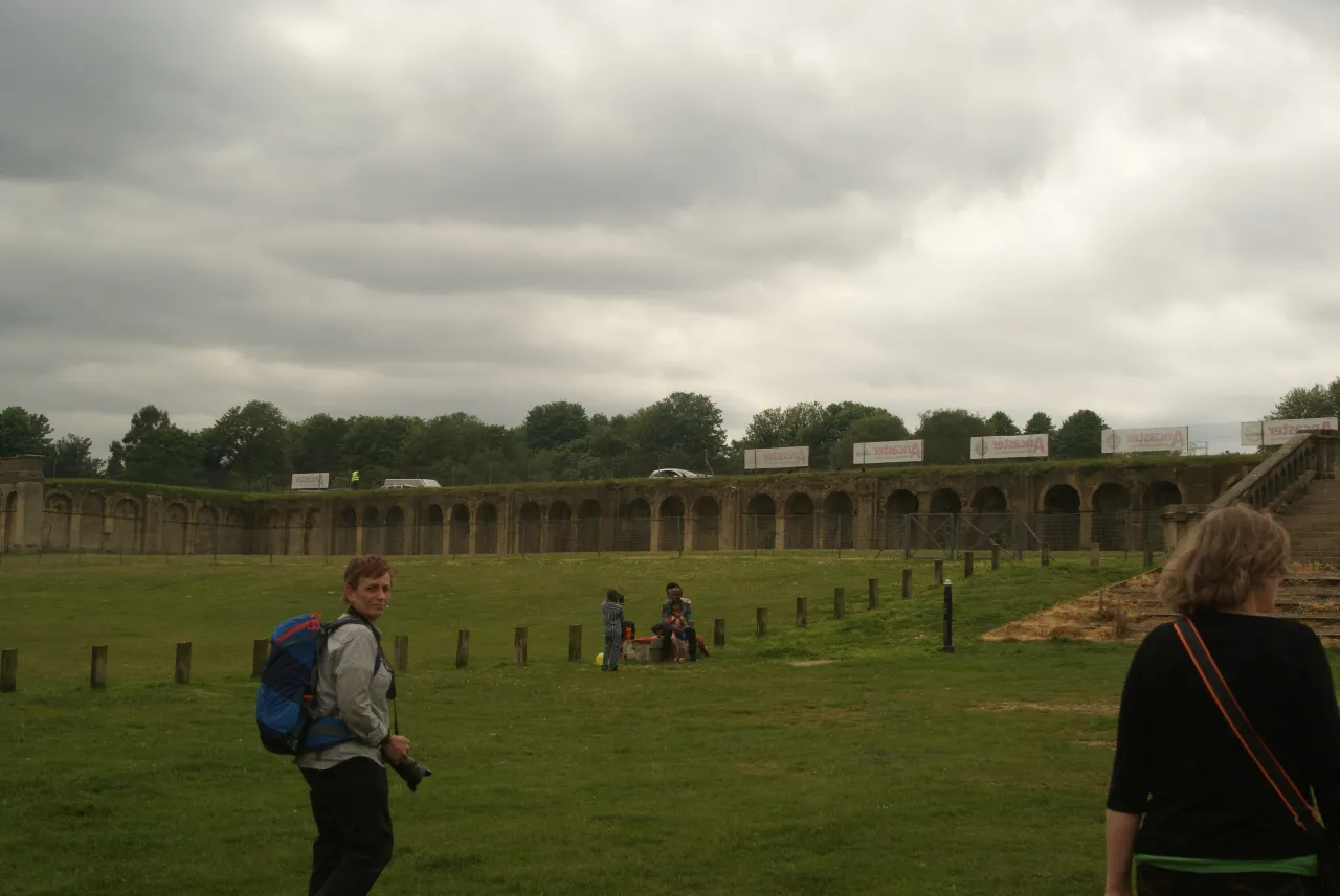 Visitors walking along the arcaded terrace remains in Crystal Palace Park
