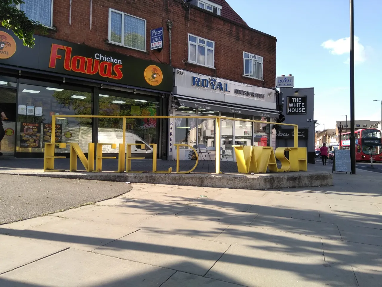 Shops on Hertford Road in Enfield Wash, including Flavas and Royal