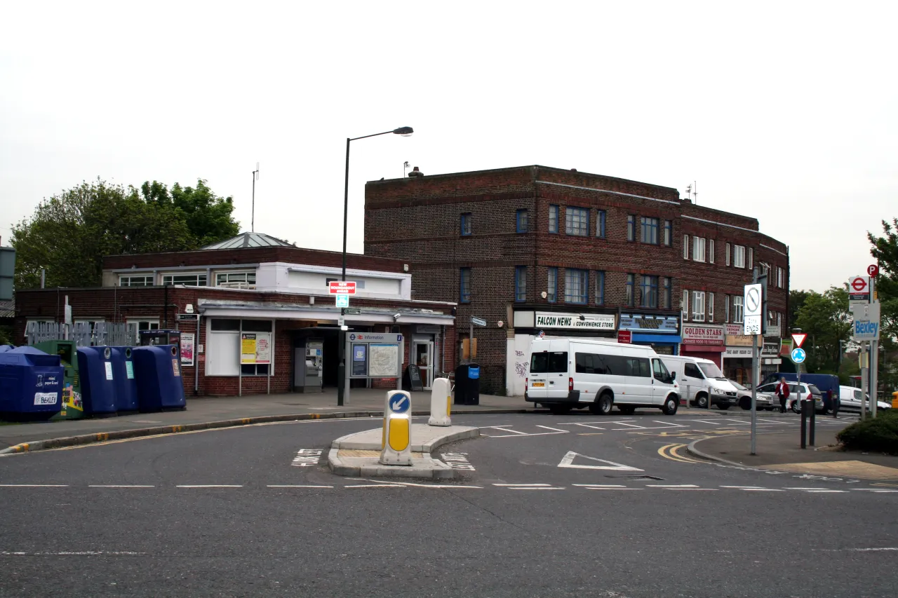 Falconwood station forecourt with the shopping parade opposite, DA16 and shopping parade