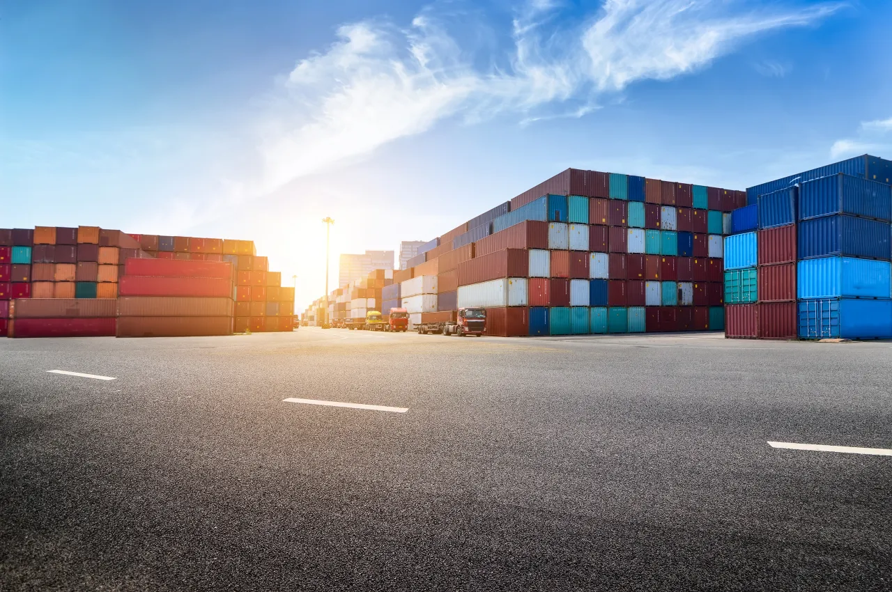 Container yard with stacked freight ready for a new customer's shipment, getting started