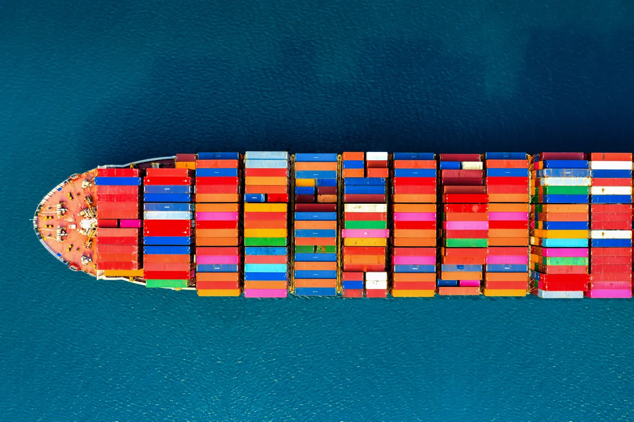 Aerial view of a fully laden container ship underway at sea, a shipment in transit