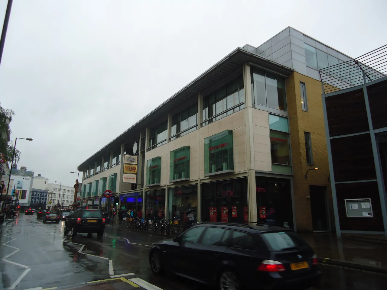 Fulham Broadway shopping centre exterior on the main road, with traffic passing