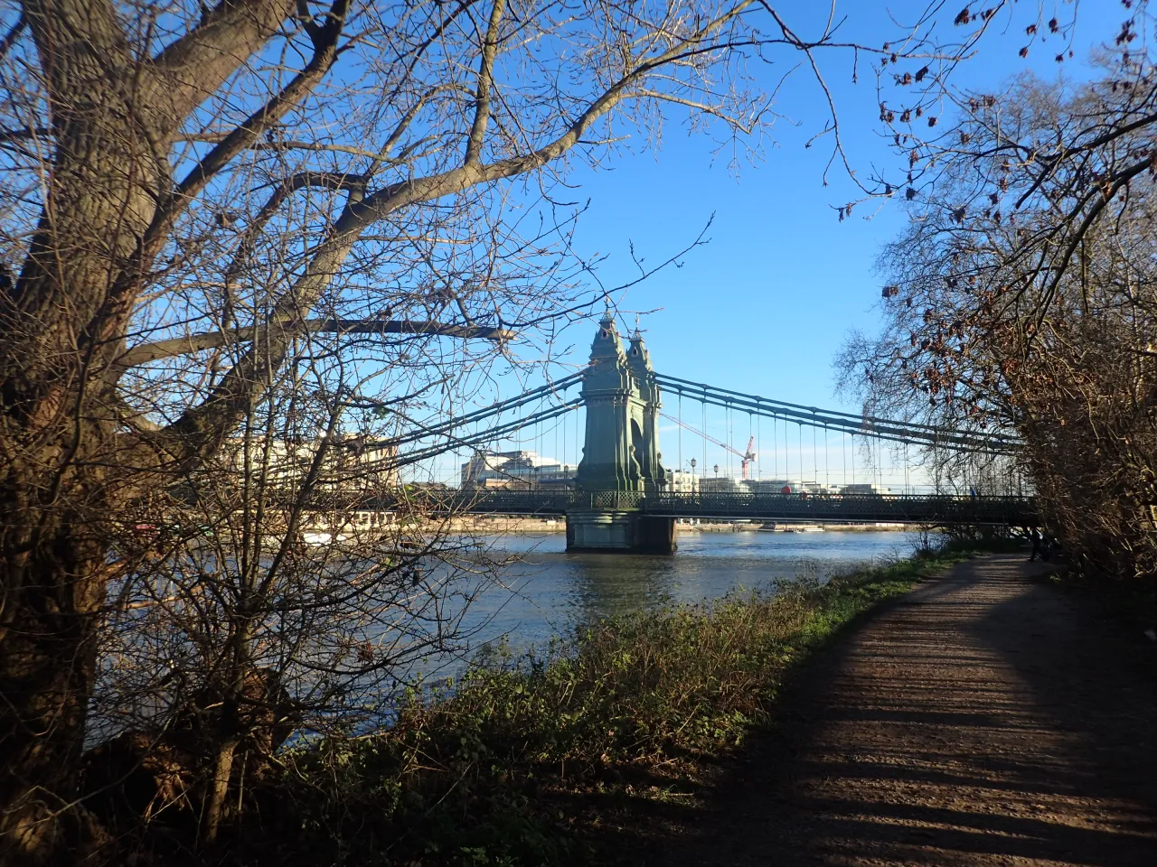 Hammersmith Bridge seen from the riverside path along the Thames