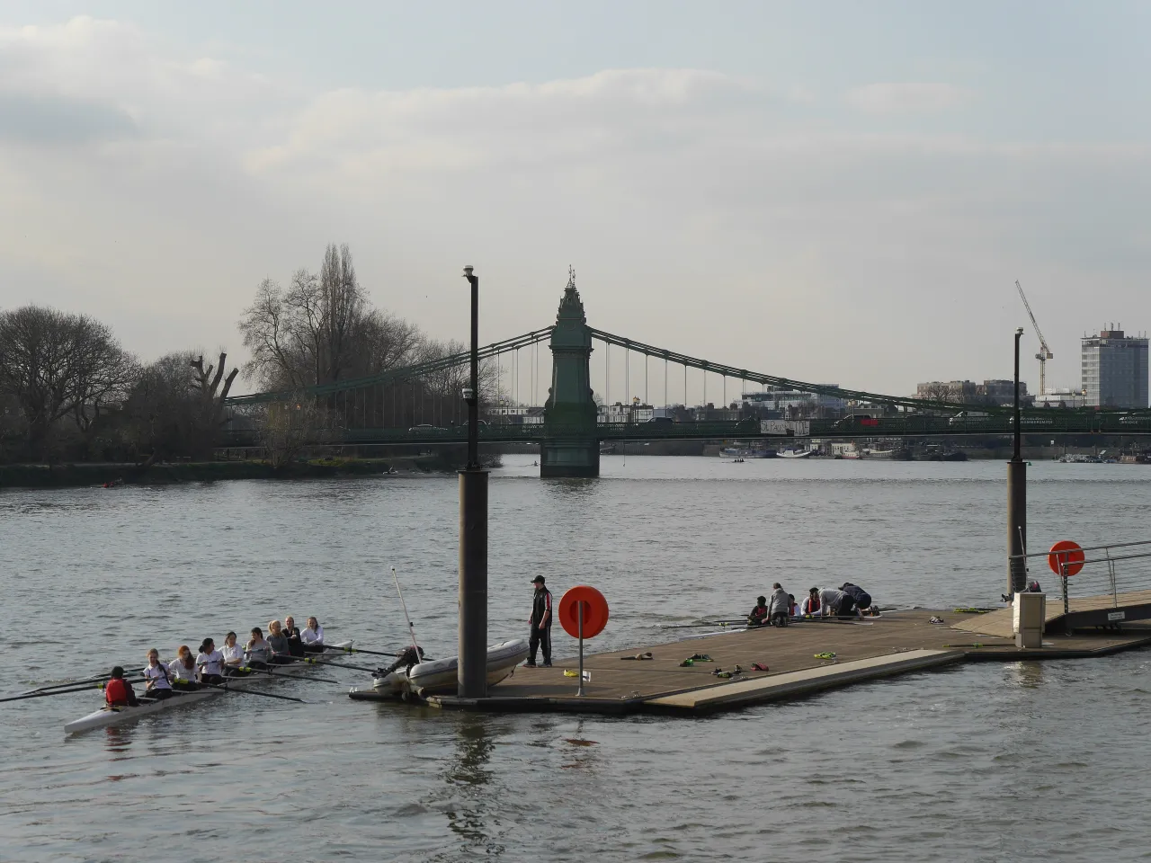 Hammersmith Bridge on the Thames with a rowing crew passing beneath
