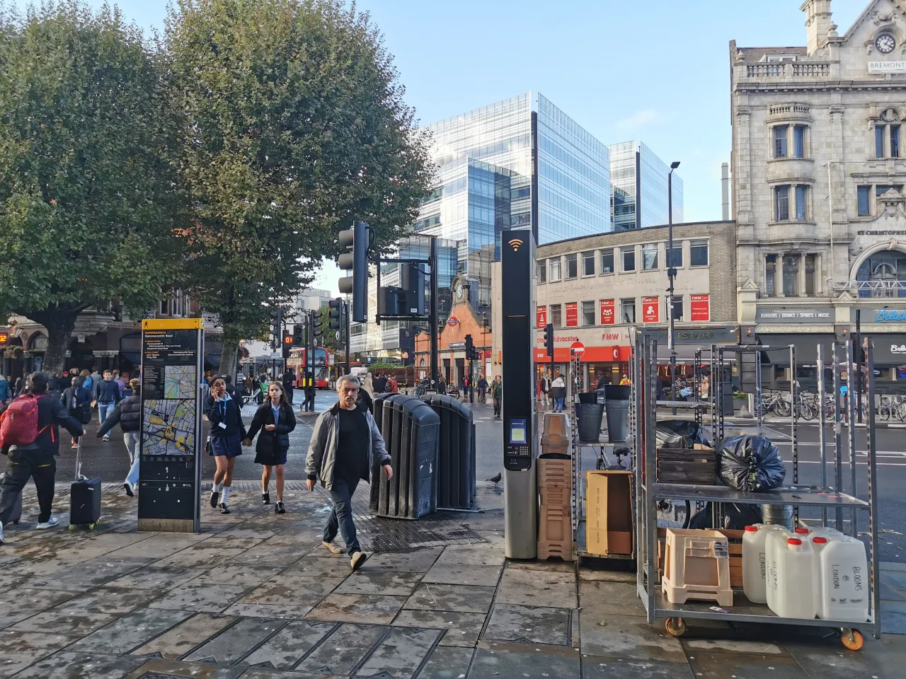 Pedestrian plaza at Hammersmith Broadway with shoppers and shopfronts