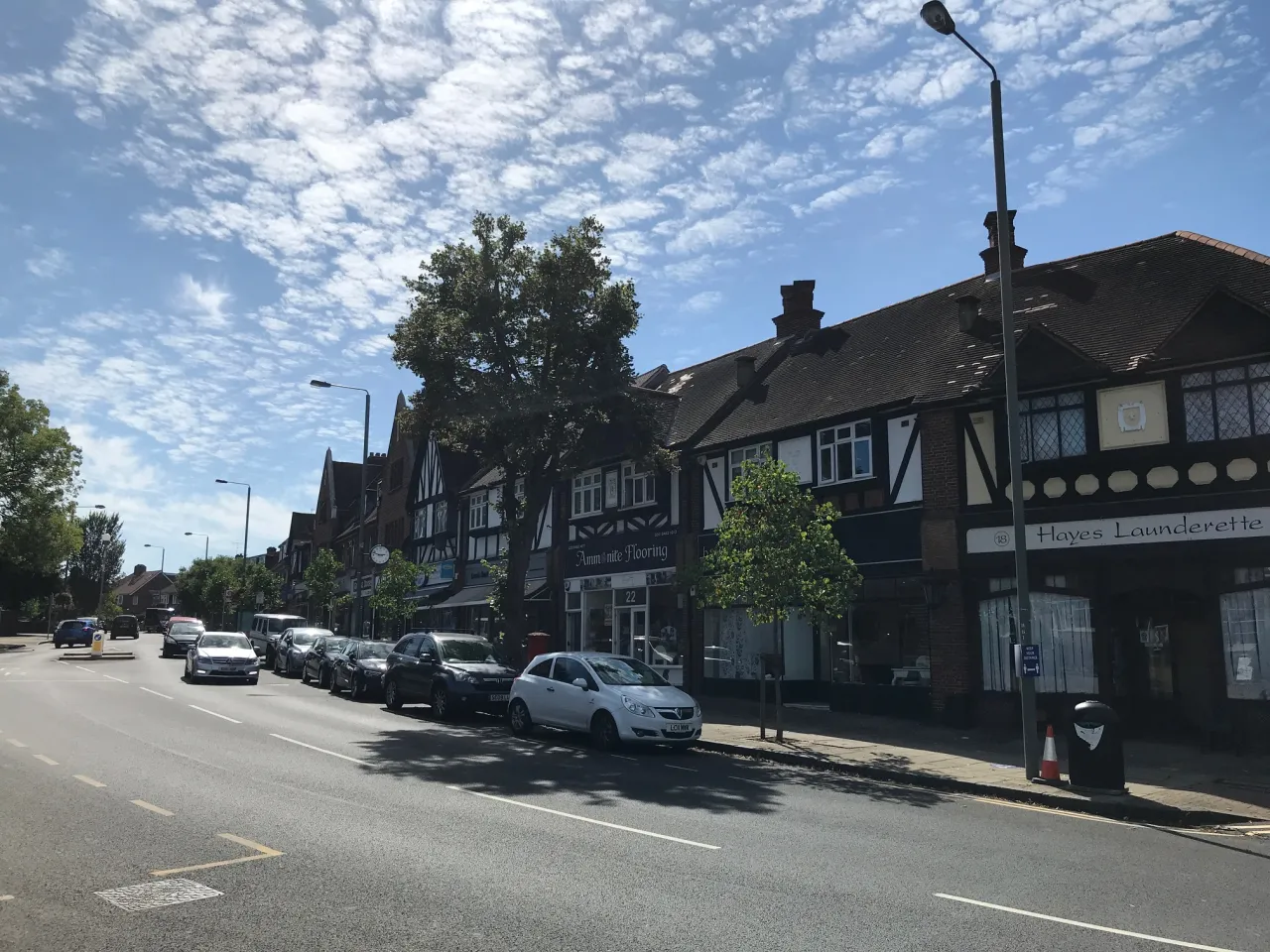 Tudor-style shops and parked cars along Hayes village high street