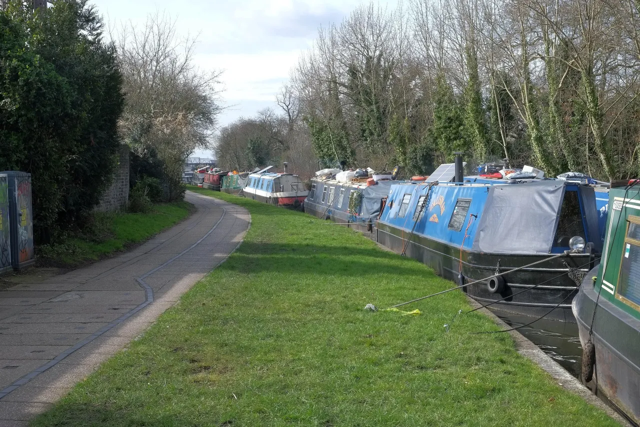 Narrowboats moored on the Grand Union Canal towpath at Kensal Green