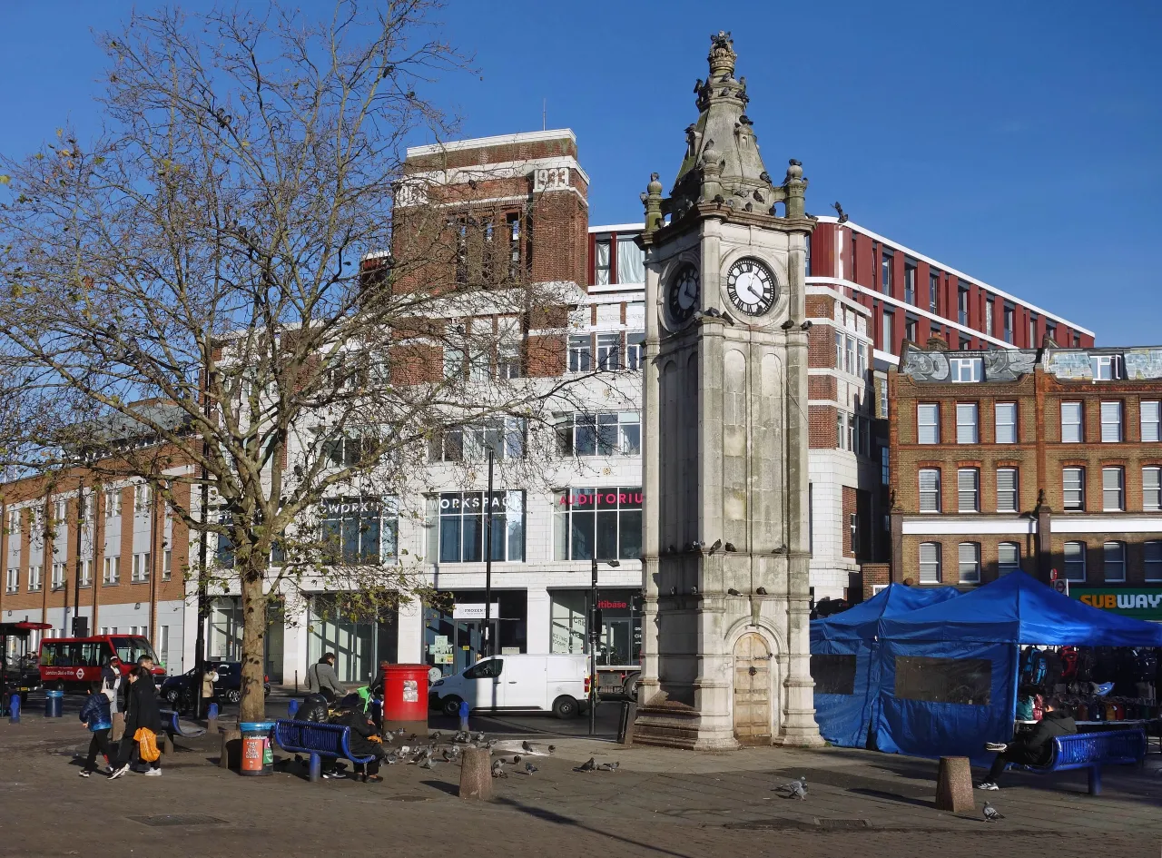Lewisham Clock Tower in the town centre, with market stalls and shops behind