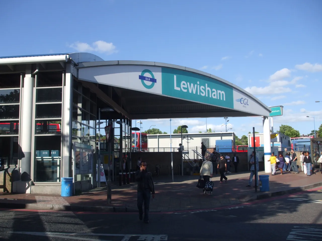 Lewisham DLR and rail station entrance, with buses and passengers outside