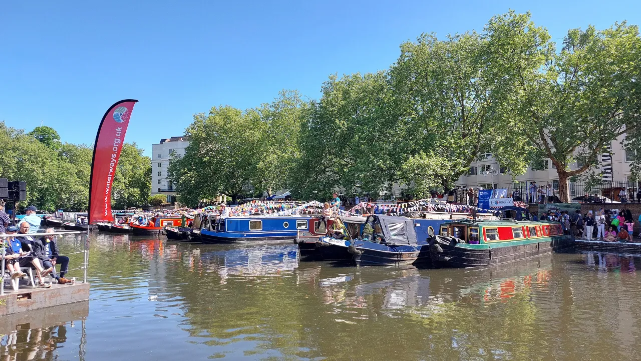 The Canalway Cavalcade festival with decorated narrowboats moored at Little Venice