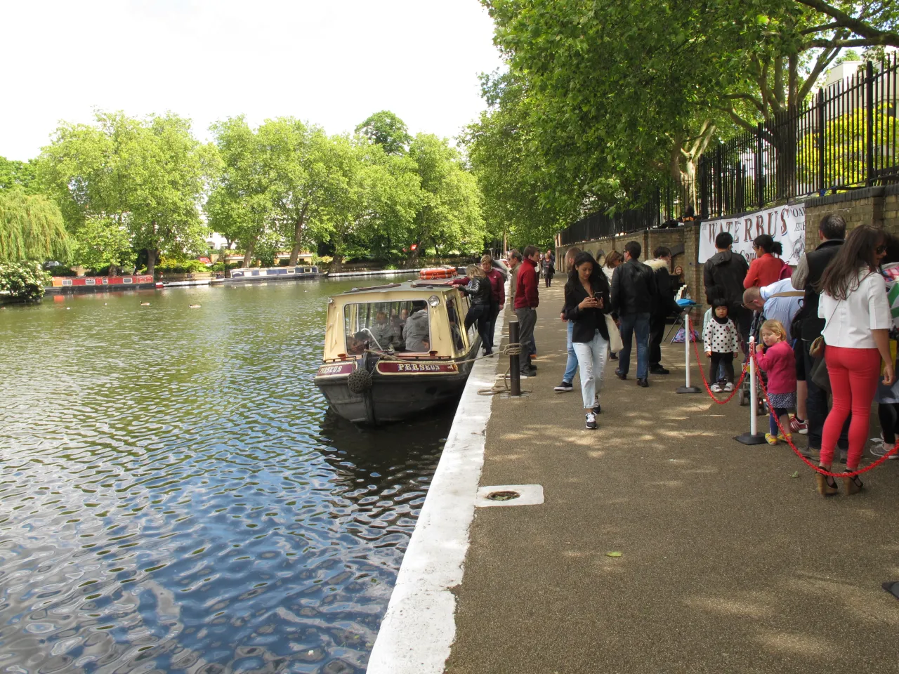 Visitors by the canal waiting for the waterbus at Little Venice
