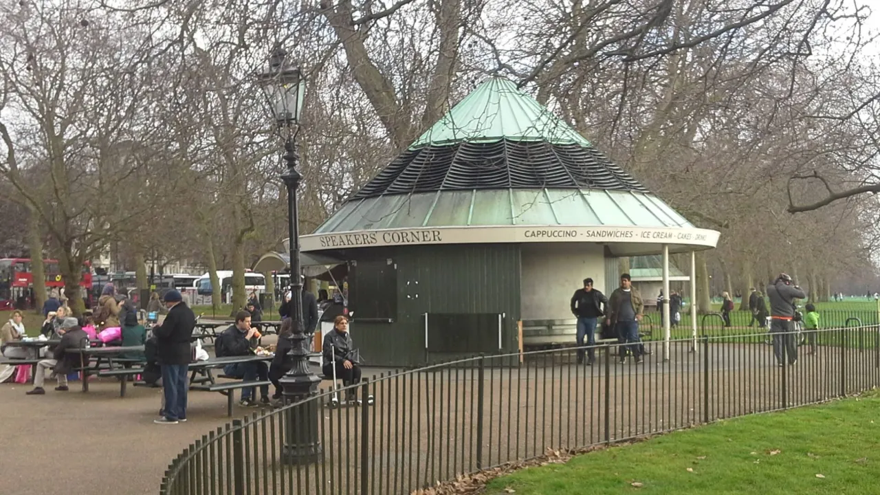 The Speakers' Corner cafe kiosk in Hyde Park, near Marble Arch, with people relaxing outside