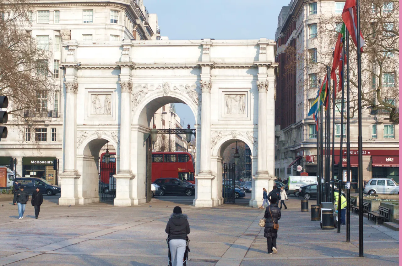 Marble Arch monument at the busy Oxford Street junction, with buses and pedestrians