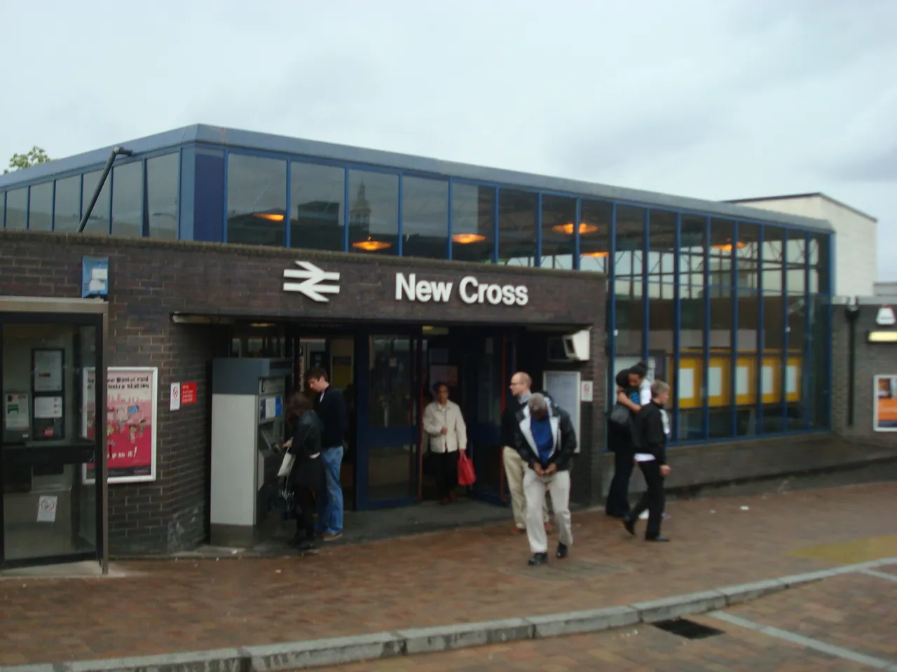 The entrance to New Cross railway station, with passengers arriving