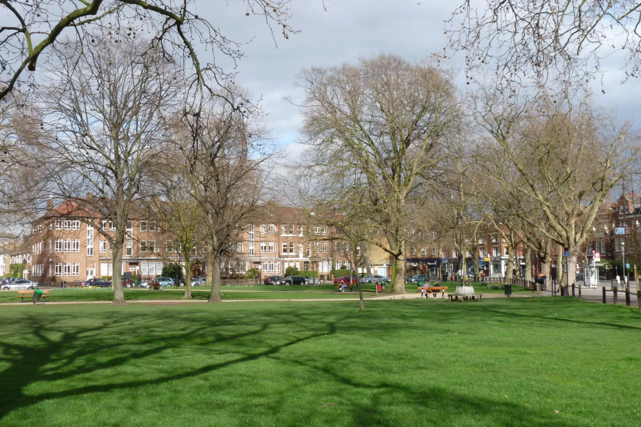 The Green at Parsons Green, an open grassy area lined with houses and trees