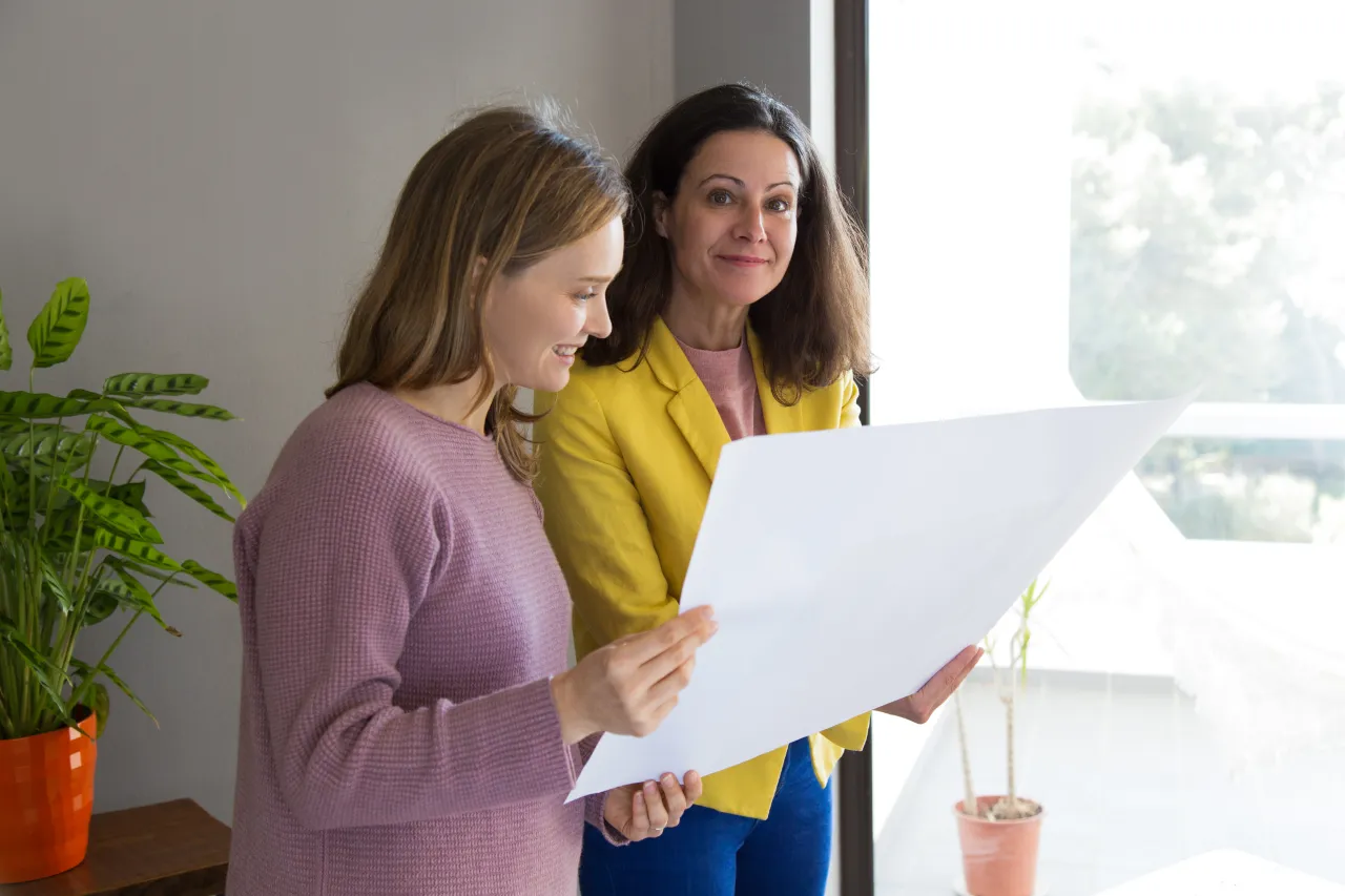 Planning consultant talking a client through a document, answering her questions