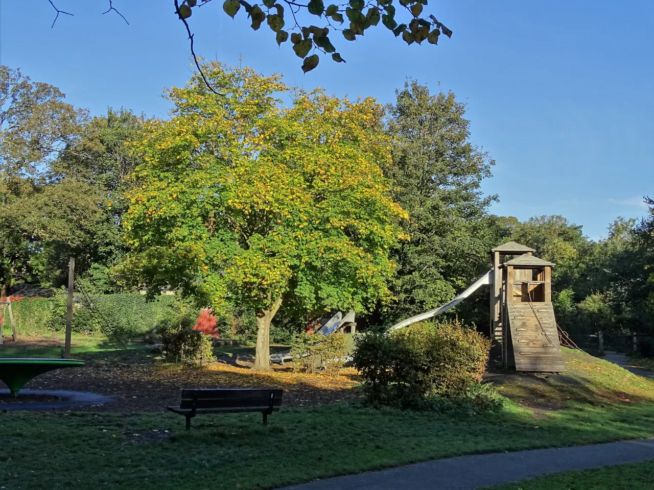 The children's play area in Ravenscourt Park, with a wooden climbing frame and slide