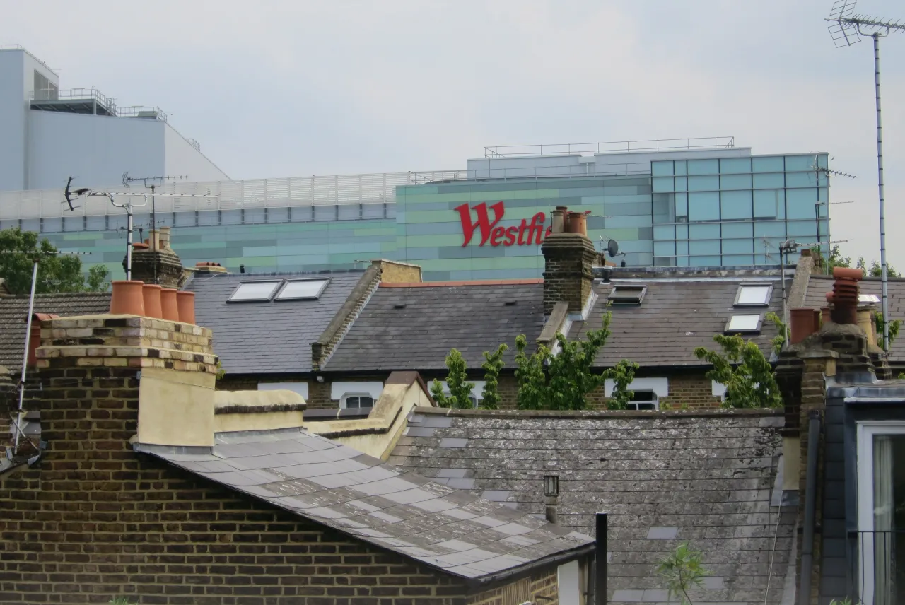 Westfield London shopping centre building exterior with rooftops in the foreground, Shepherds Bush