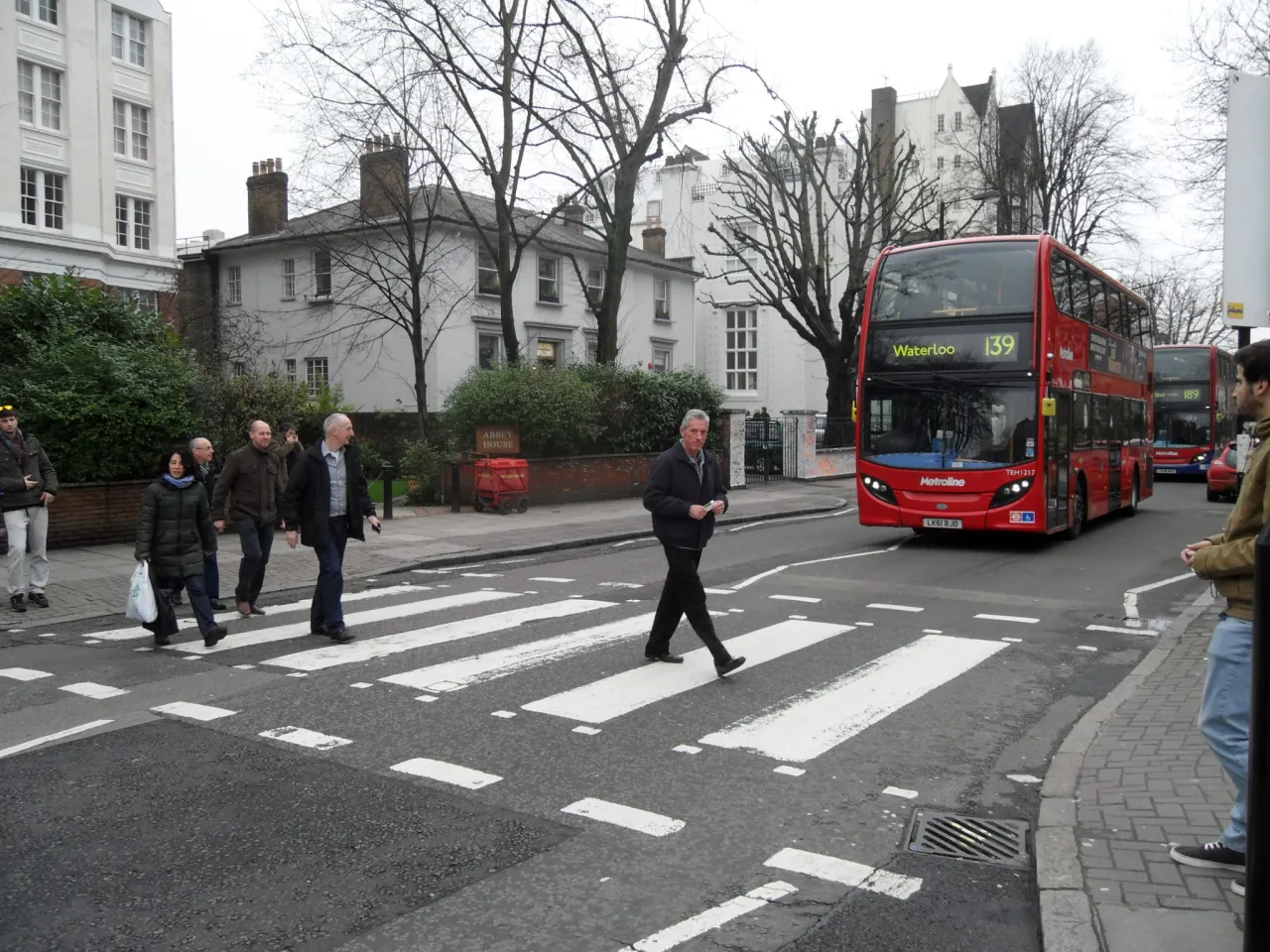 Pedestrians crossing the Abbey Road zebra crossing in St John's Wood