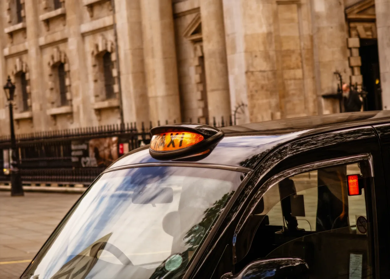 A licensed London black cab parked near Trafalgar Square, ready to work