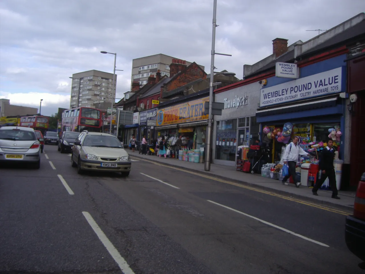 Shops and traffic along Wembley High Road on a sunny day
