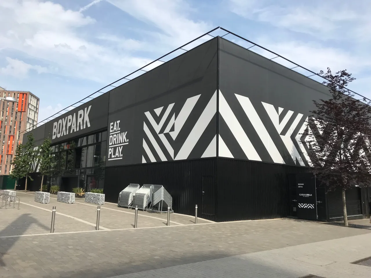 Boxpark Wembley's striped exterior on a clear day