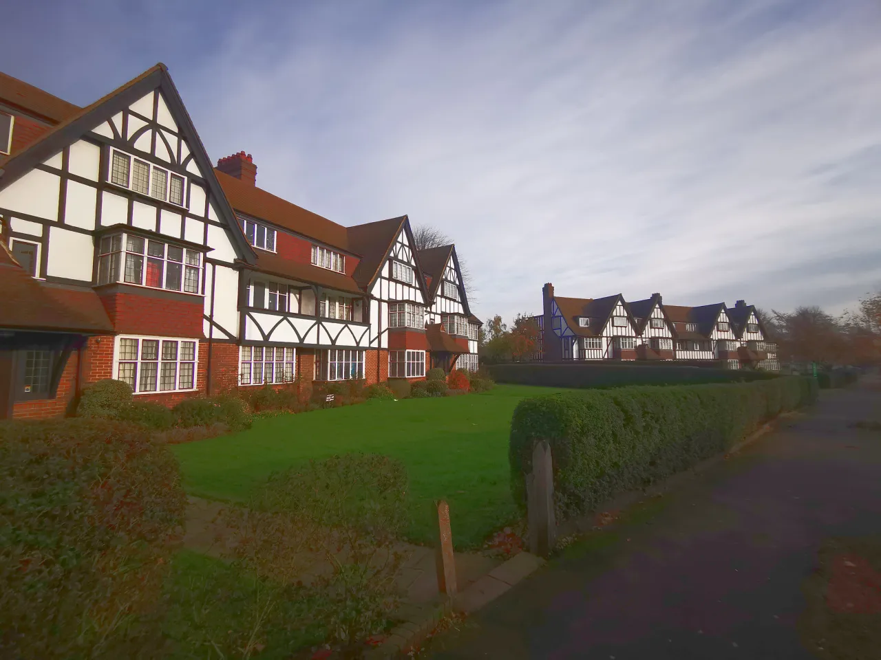 Mock-Tudor houses on Queens Drive in West Acton, Ealing, with front lawns and hedges