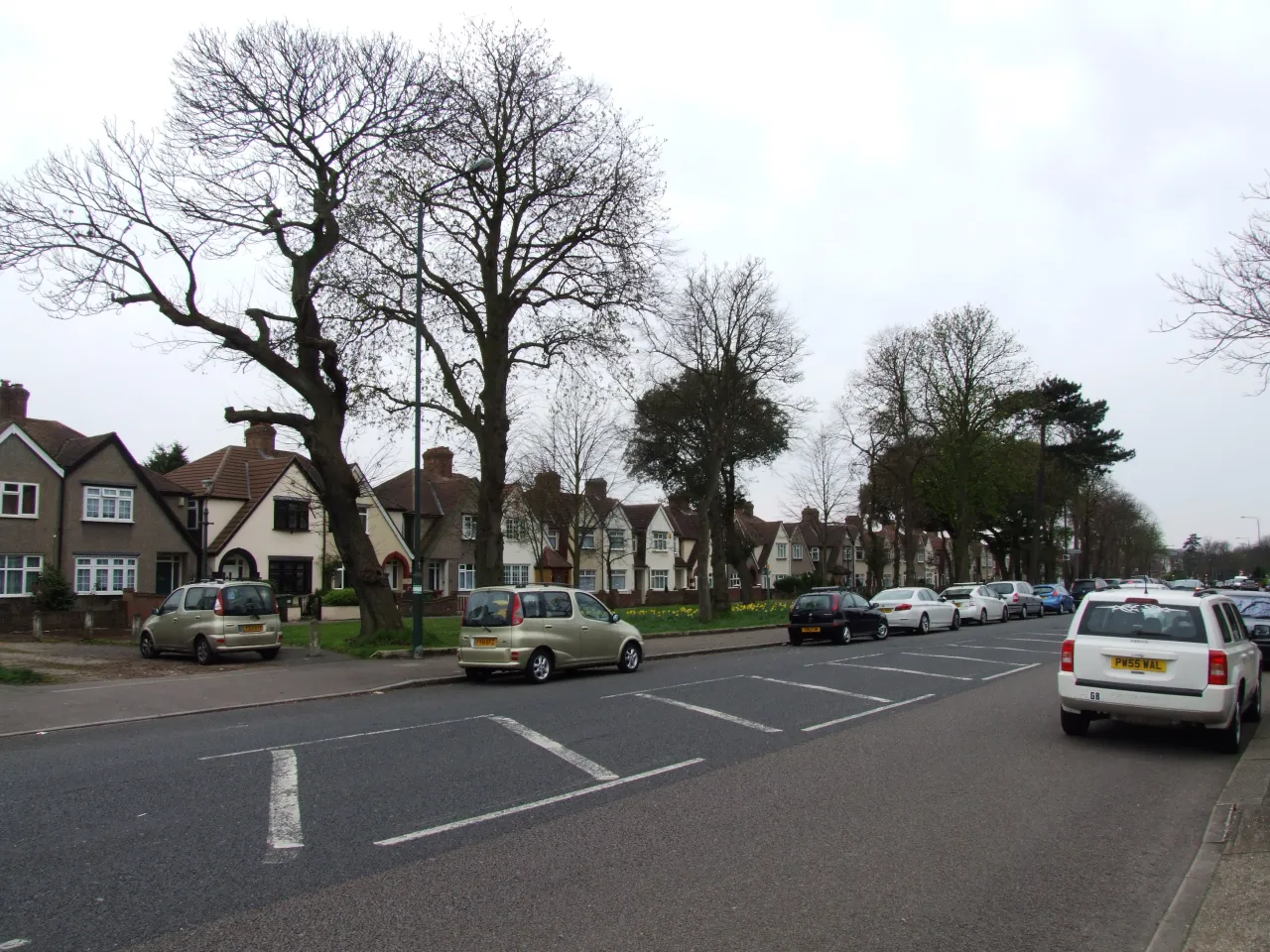 Woolwich Road in West Heath, a wide tree-lined residential road, different section from the hero view