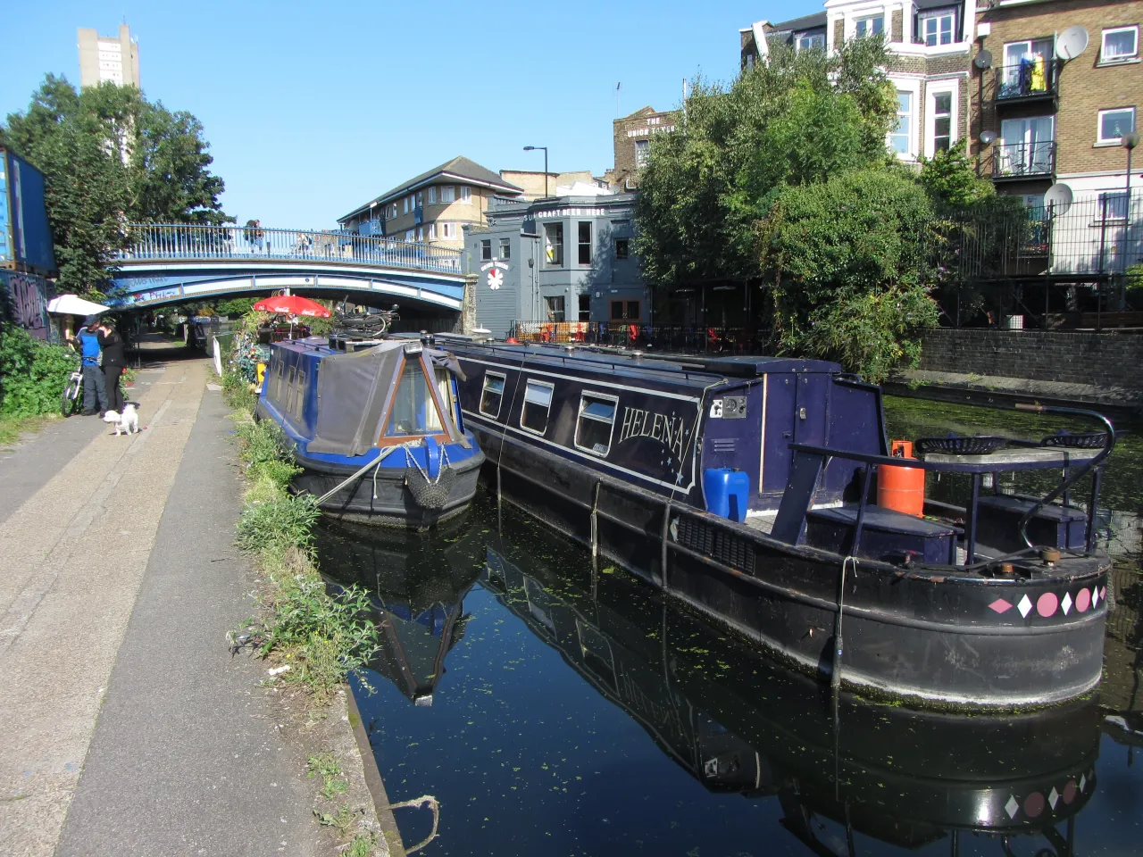 The Grand Union Canal at Westbourne Park, with moored narrowboats and a footbridge