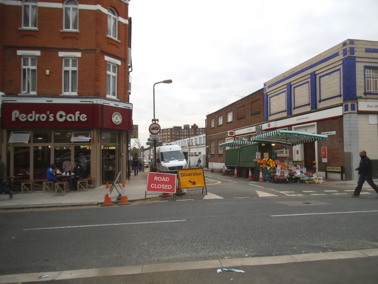 Shops and a cafe on Cricklewood Broadway at Oaklands Road, the high street next to Willesden Green